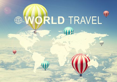 Contoured map of world continents with inscription World Travel and related symbol. Aerial view of a few air baloons, sky and cloud layer as backdrop