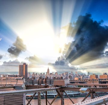 Beautiful sunset sky above Midtown Manhattan. View from Brooklyn Bridge.