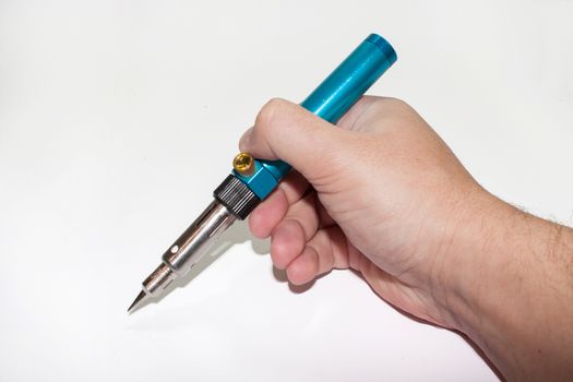 Gas soldering iron in the hand on the white background.