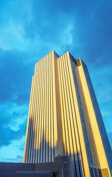 High Tower building against blue sky at sunset.