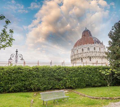 Pisa. Baptistery in Square of Miracles as seen from a nearby garden.