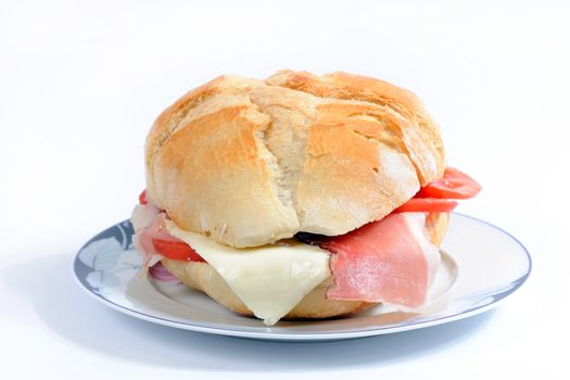 Realization sandwich stuffed with speck ham, cheese and tomato.