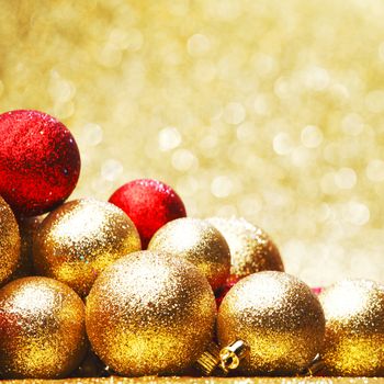 Golden Christmas ball on abstract glitter background