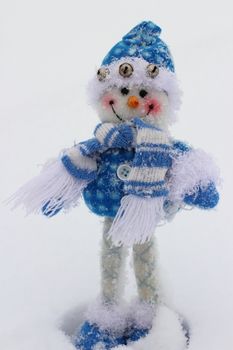 toy snowman in the street in winter clothes