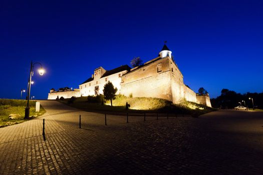 Old fortress "Cetatuia" illuminated at night, Brasov, Romania