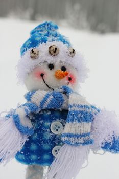 toy snowman in the street in winter clothes