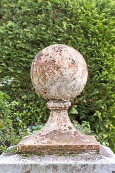 A weathered stone wall bollard