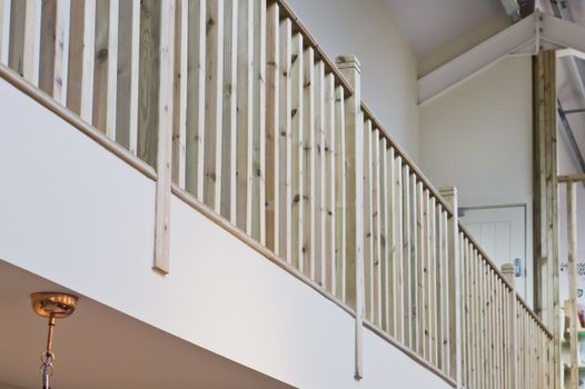 Modern interior wooden bannister on a balcony