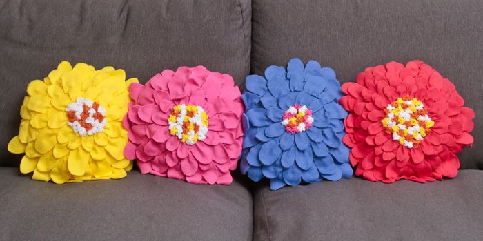 Row of colorful home made fleece cushions with a floral pattern
