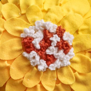 Part of a yellow home made flowery fleece cushion