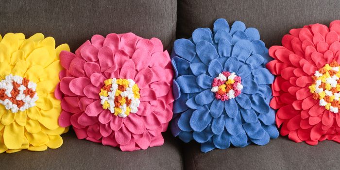 Row of colorful home made fleece cushions with a floral pattern