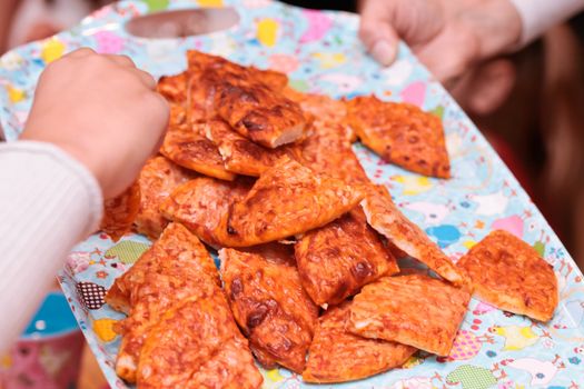 Pizza being served on a tray at a children's party