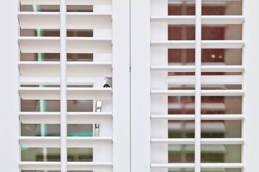 Part of a modern white wooden blind