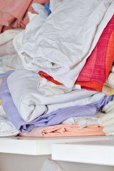 Piles of bed sheets on a shelf