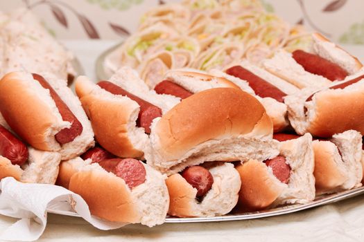 Plate of freshly made hot dogs on a buffet table