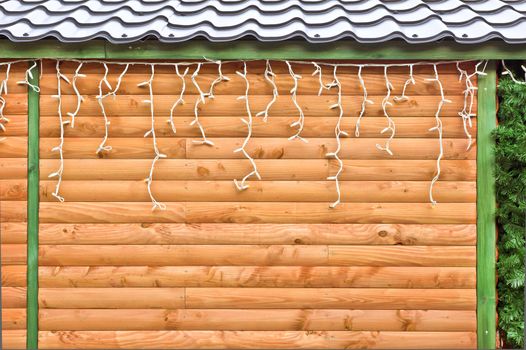 Fairly lights hanging on a wooden cabin