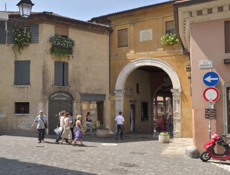 People going into the Alpini  bridge, in the street  Pusterla  in Bassano del Grappa, a city, in the Vicenza province, in the region Veneto, in northern Italy.