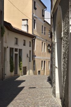 Narrow street in the historical part of the town of Bassano del Grappa, Italy