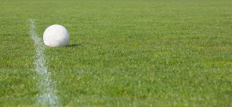 Football on an empty pitch on a clear day