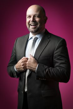 image of a laughing business man with a magenta background