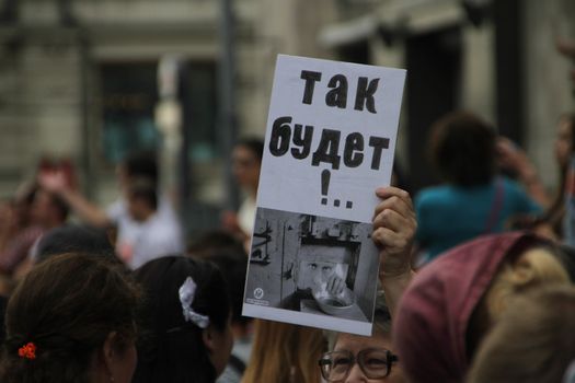 Moscow, Russia - July 18, 2013. Unknown oppositionist with anti Putin opposition placard stock. Thousands of Muscovites went on this day in support of arrested opposition leader Alexei Navalny