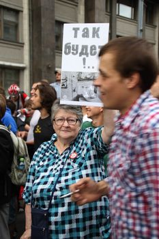 Moscow, Russia - July 18, 2013. Unknown oppositionist with anti Putin opposition placard stock. Thousands of Muscovites went on this day in support of arrested opposition leader Alexei Navalny