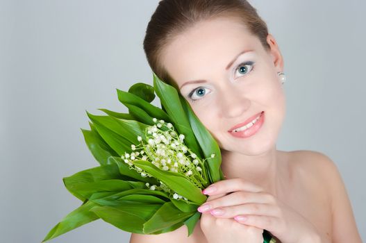 portrait of the girl with a bouquet of lilies of the valley