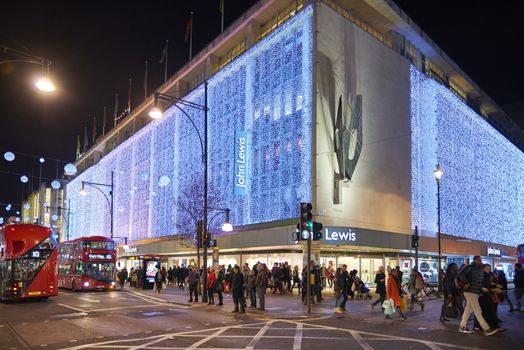 LONDON, UK - DECEMBER 20: Nighttime shot of John Lewis department store exterior in busy Oxford  street with wall of lights as part of its Christmas decorations. December 20, 2014 in London.