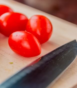 Tomatoes On Board Indicating Fresh Food And Cooking