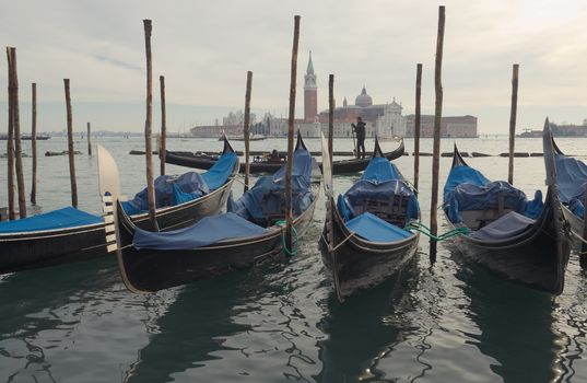 Gondolas in front of the island of San Giorgio in Venice in winter evening