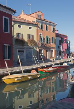 Colorful houses and boats on the island of Burano near Venice