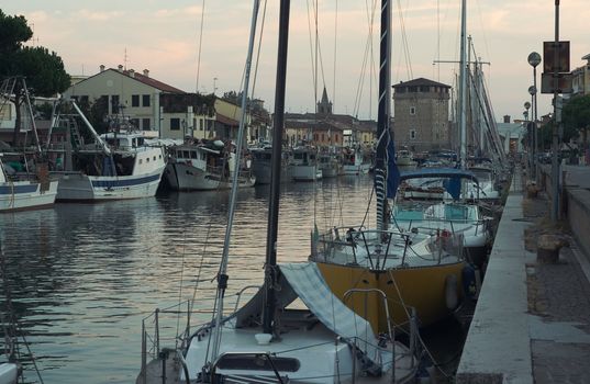 Fishermen's port in the rays of the setting sun. Cervia, Italy.