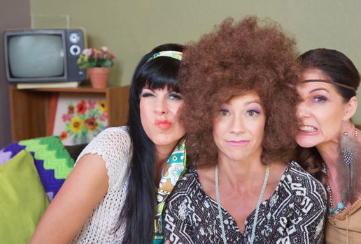 Three cute women in 1960s fashion making faces