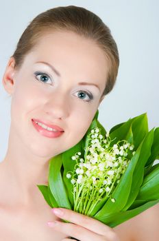 portrait of the girl with a bouquet of lilies of the valley