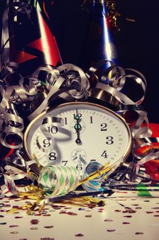 Alarm clock and decorations on table with festive background