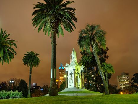 Night shot of a statue in inner city park.