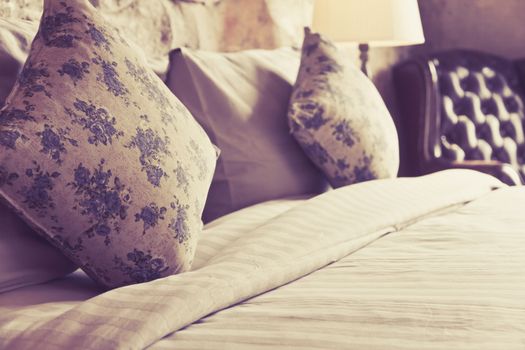 close up image of pillows on an antique luxury bed