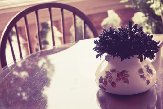 Image of vintage chair and table with flower