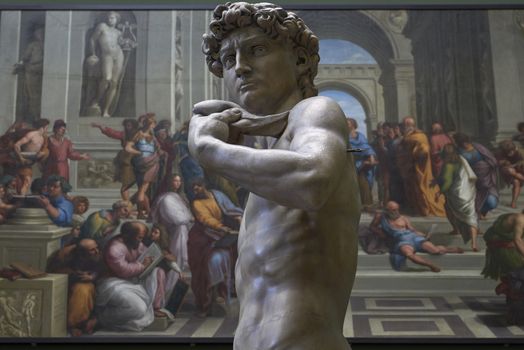 LONDON, UK - DECEMBER 20: Detail of plaster cast copy of Michelangelo's David with copy of School of Athens, by Raphael, in the background, at Victoria and Albert museum. December 20, 2014 in London.