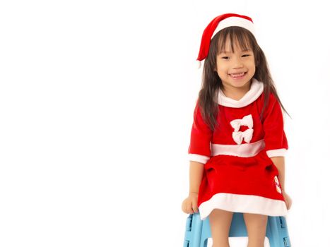 Asian little girl in red santa hat on white background