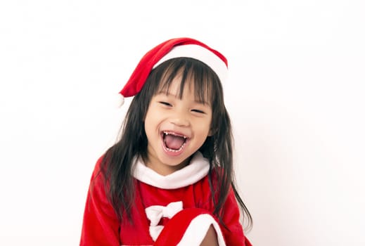 Asian little girl in red santa hat on white background