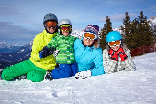 Skiers, sun and fun - Family enjoying winter vacations.