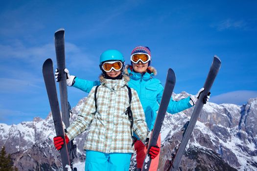 Ski, winter, snow, skiers, sun and fun - Family - mother and daughter enjoying winter vacations.