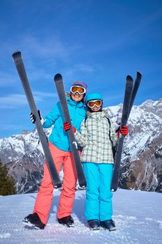 Ski, winter, snow, skiers, sun and fun - Family - mother and daughter enjoying winter vacations.