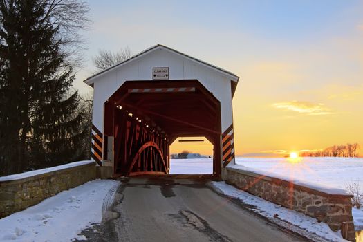 A covered bridge at sunset in Lancaster County, Pennsylvania, USA.