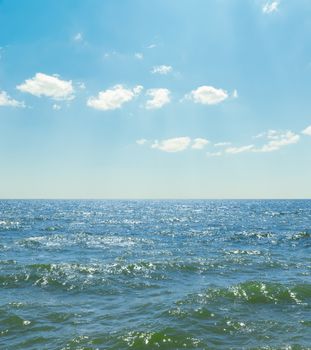 waves on sea and blue sky with clouds