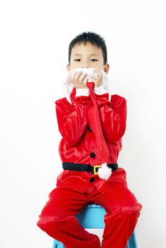 Asian little boy in red santa hat on white background