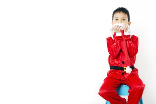 Asian little boy in red santa hat on white background