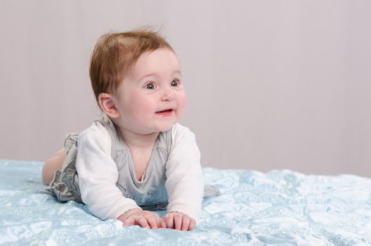 Six-month beautiful charming girl on the couch