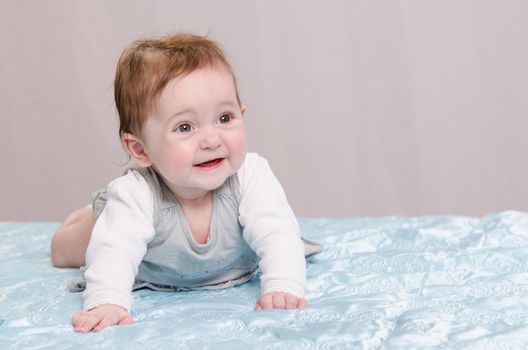 Six-month beautiful charming girl on the couch